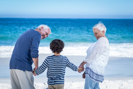 Taking Grandchildren on holiday - boy holding his Grandparents hands