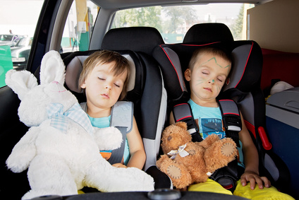 Taking Grandchildren on holiday - Two boys in car seats, travelling, sleeping in the car with teddy bears