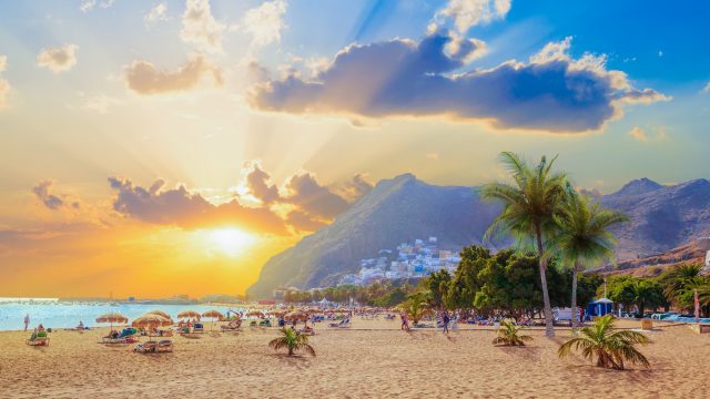 Beach in Tenerife with mountains overlooking